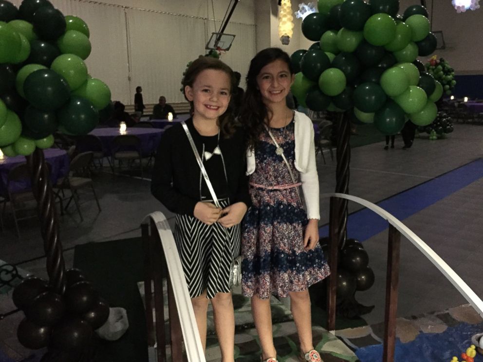 PHOTO: Angelina Saputo, 10 (right), and her best friend, Ellcy Miller, 9 (left) seen at the father-daughter dance at Trinity Lutheran School in Elkhart, Indiana. 