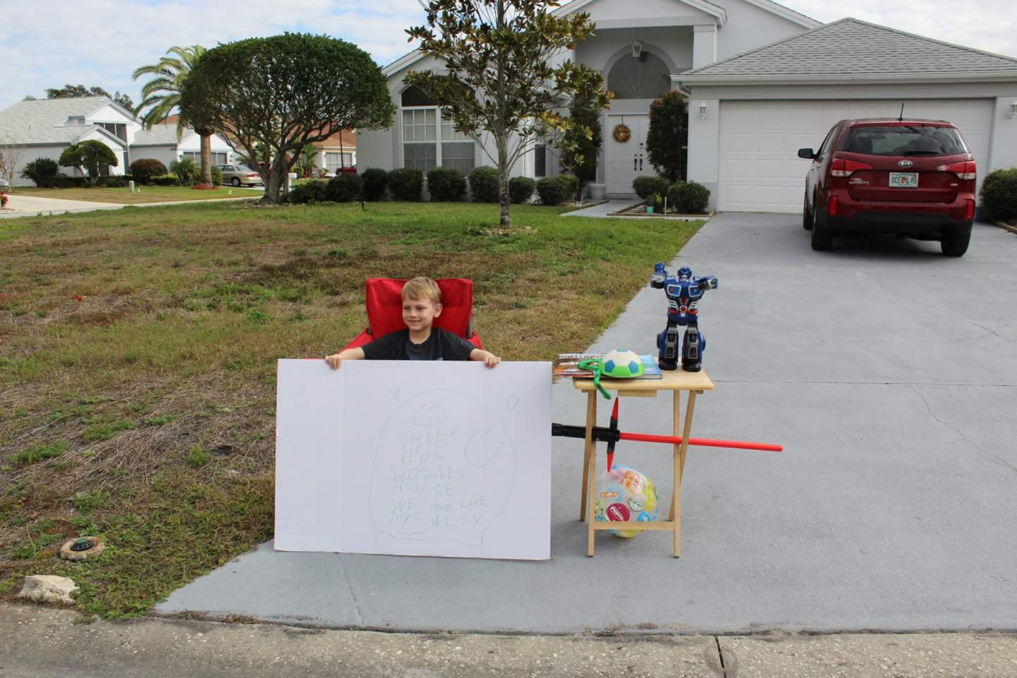 PHOTO: Little boy, Blake Work, paid it forward by holding a "free toy" stand for children who are less fortunate. 