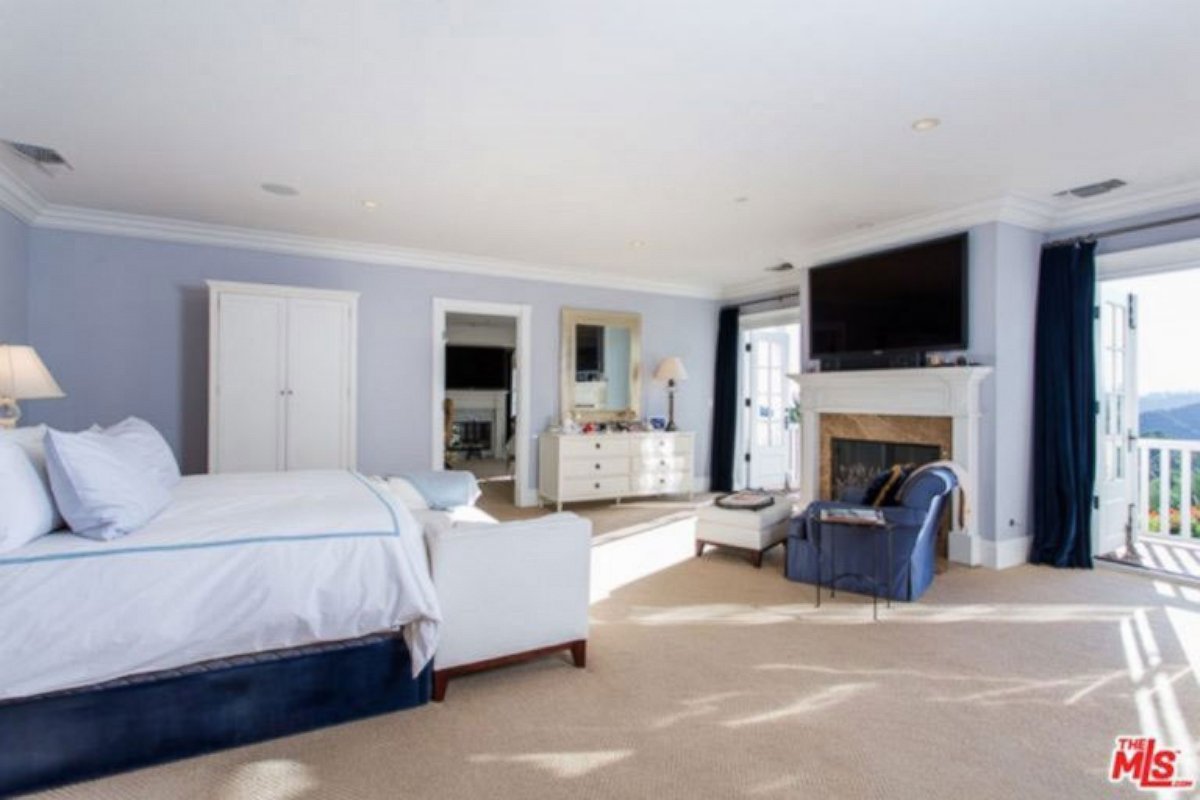 PHOTO: This huge bedroom - one of seven in the home - boasts a fireplace and views of Beverly Hills.
