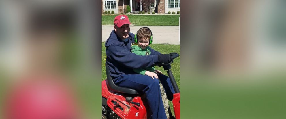 PHOTO: Brian Kelly, 5, rides with his dad, Dan Kelly, on the lawnmower before Kelly's deployment.