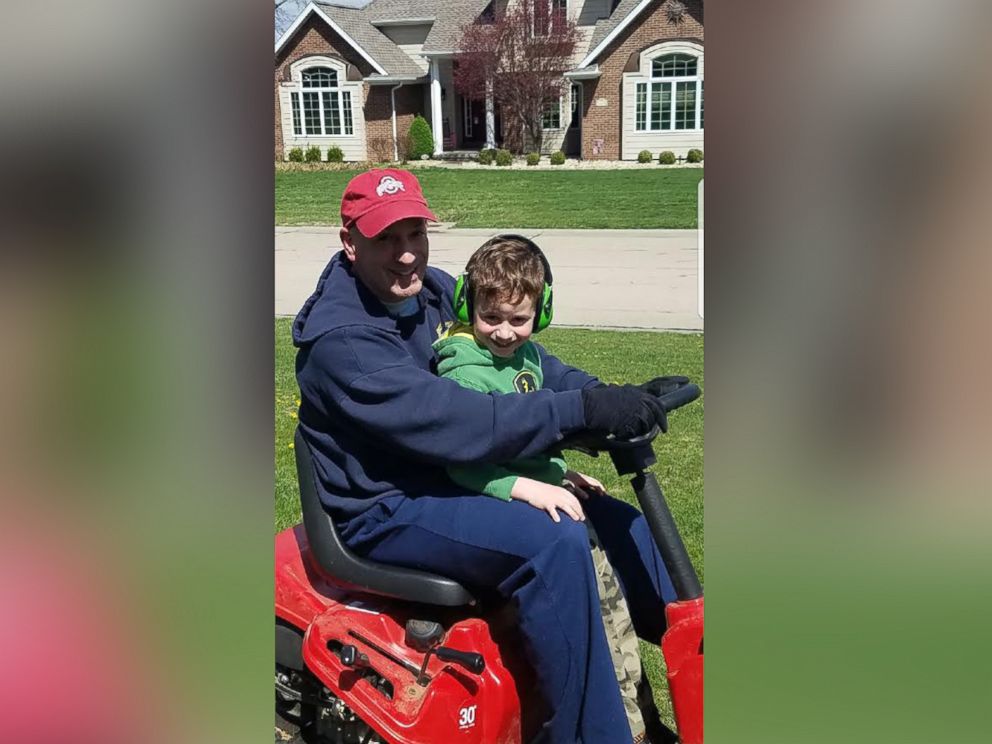 PHOTO: Brian Kelly, 5, rides with his dad, Dan Kelly, on the lawnmower before Kellys deployment.