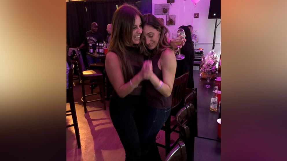PHOTO: Andrea Sealy dancing with friend Catherine Harvey at her goodbye party inside Bop on Broad Street.