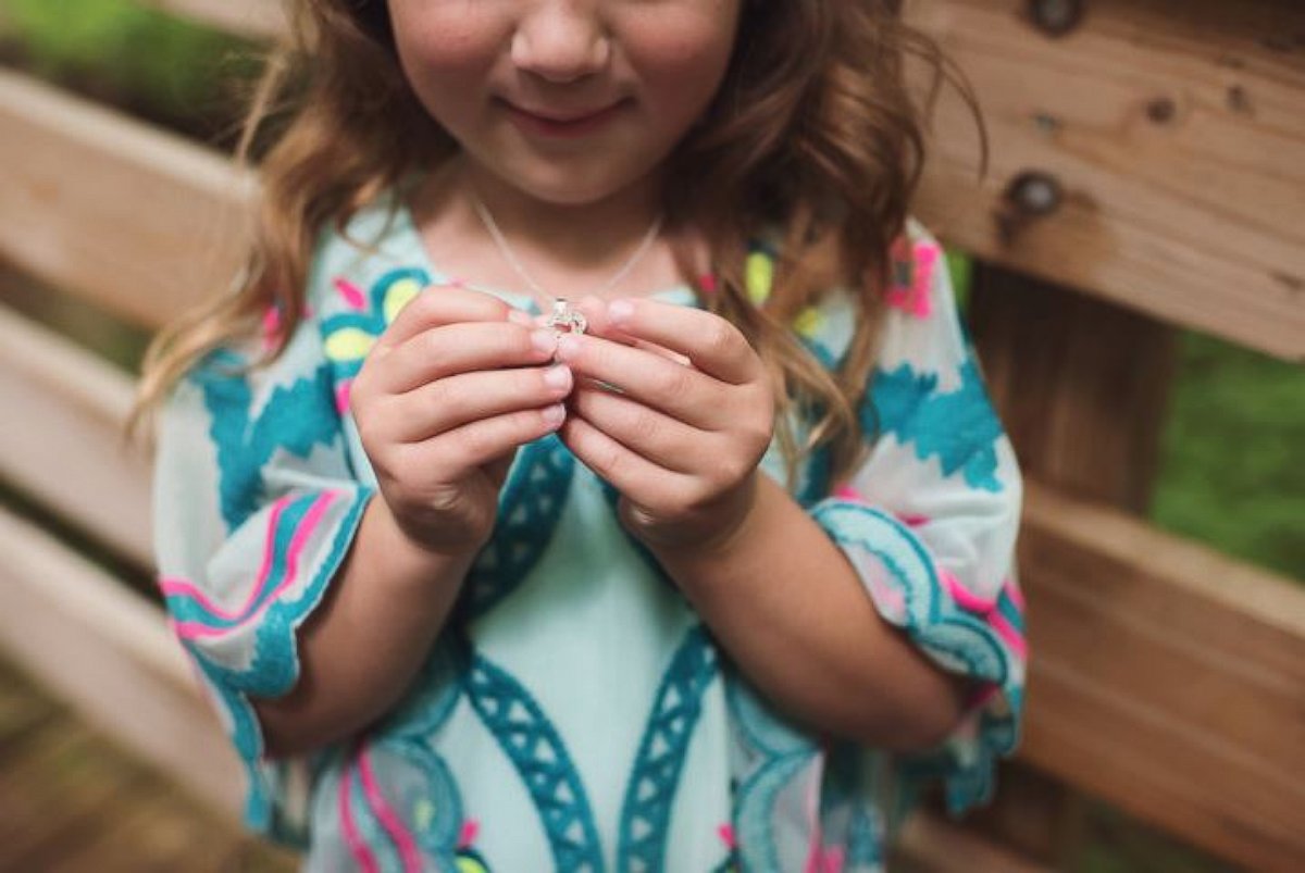 PHOTO: Grant Tribbett proposes to his girlfriend Cassandra Reschar and her 5-year-old daughter, Adrianna, on May 27, 2017.