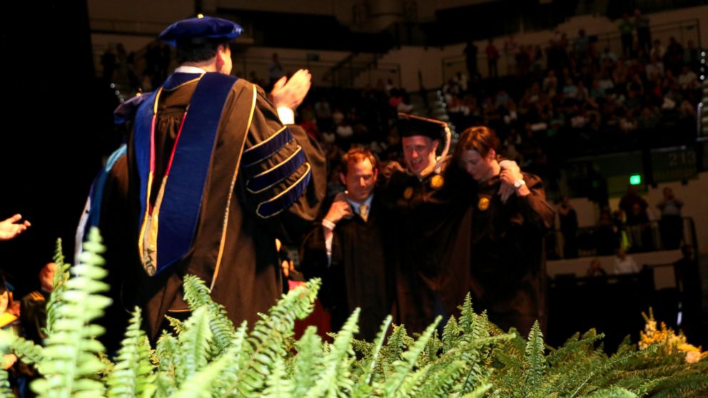 VIDEO: Sam Bridgman, 25, has a rare disease that causes nervous system damage and movement problems, but with some help, he stood up and walked at his University of South Florida Muma College of Business graduation ceremony.