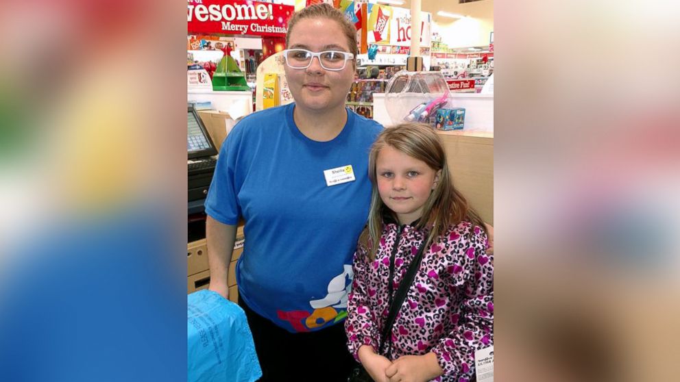 Sheilla Nelson, 17, photographed with Violet Provencher, 8, at a Toys R' Us in Manchester, N.H. on Black Friday. 
