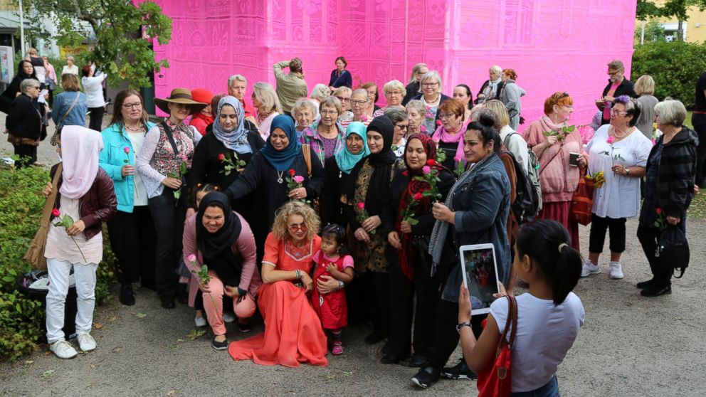 The stories of Olek's Syrian and Ukrainian refugee volunteers inspired her to create the pink house.
