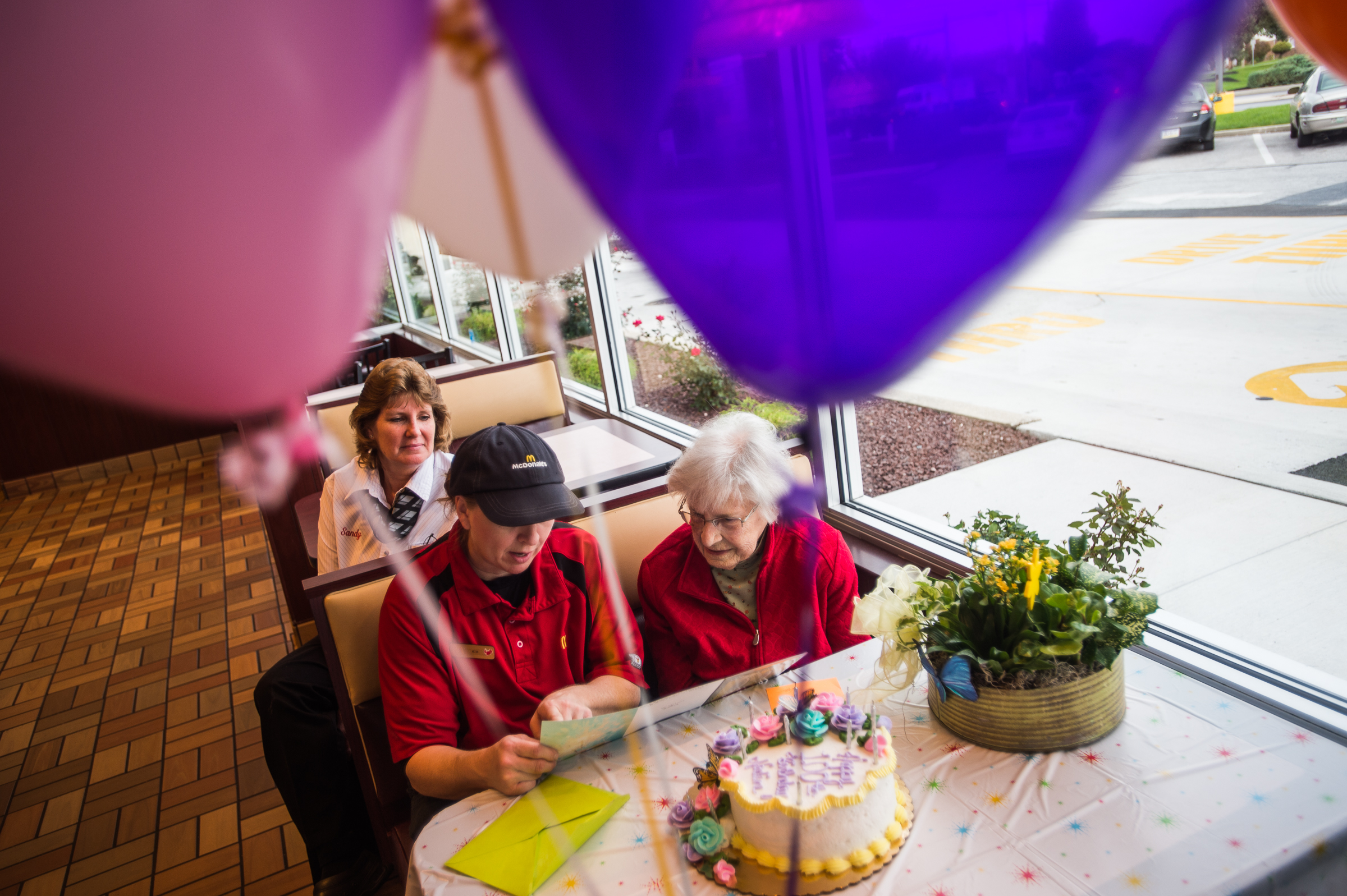 PHOTO: Nadine Baum reads a birthday card with McDonald's employee Kim Birgensmith and manager Sandy Arentz, background, Oct. 13, 2016 at the south Hanover McDonald's.