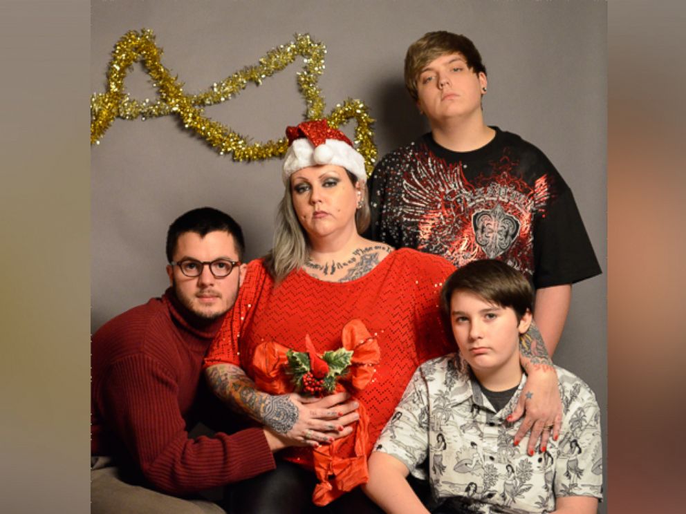 PHOTO: Josh Brassow, 25, poses with strangers for a Christmas card he staged to prank his family members.