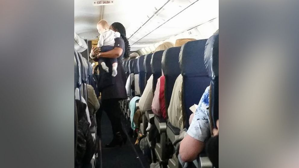 Heather Gooch shared a photo on Facebook of her 9-month-old son, Aiden, being held by a Southwest Airlines flight attendant.