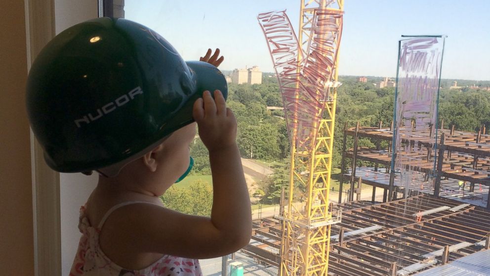 PHOTO: Vivian Keith, 2, who is battling leukemia, often looks out her window to watch the hospital construction workers from St. Louis Children's Hospital in St. Louis, Mo.  