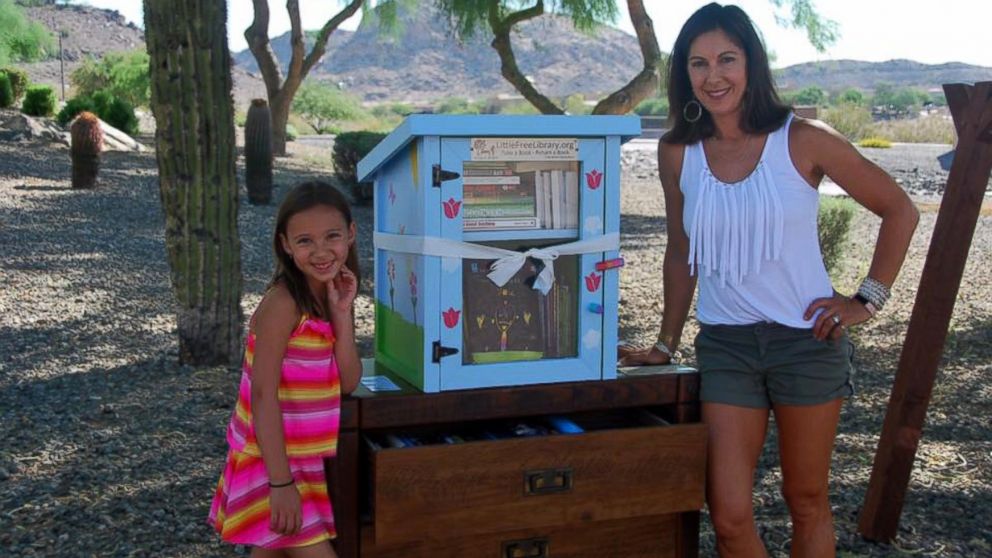 Anna Wolcott, 6, photographed with her mother Heather on June 25 at the grand opening of her "Little Free Library," which was reported stolen by a neighbor on July 2.  