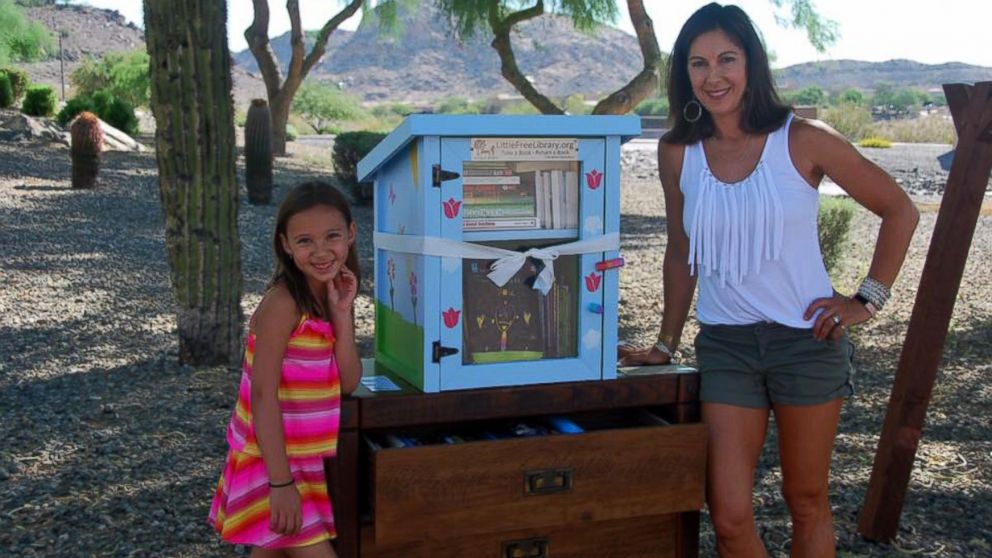 Anna Wolcott, 6, photographed with her mother Heather on June 25 at the grand opening of her "Little Free Library," which was reported stolen by a neighbor on July 2.