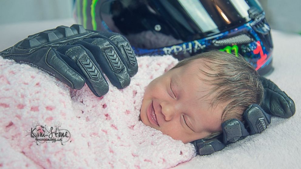 A newborn baby photographed with her deceased dad's possessions has captured the heart of the internet. 