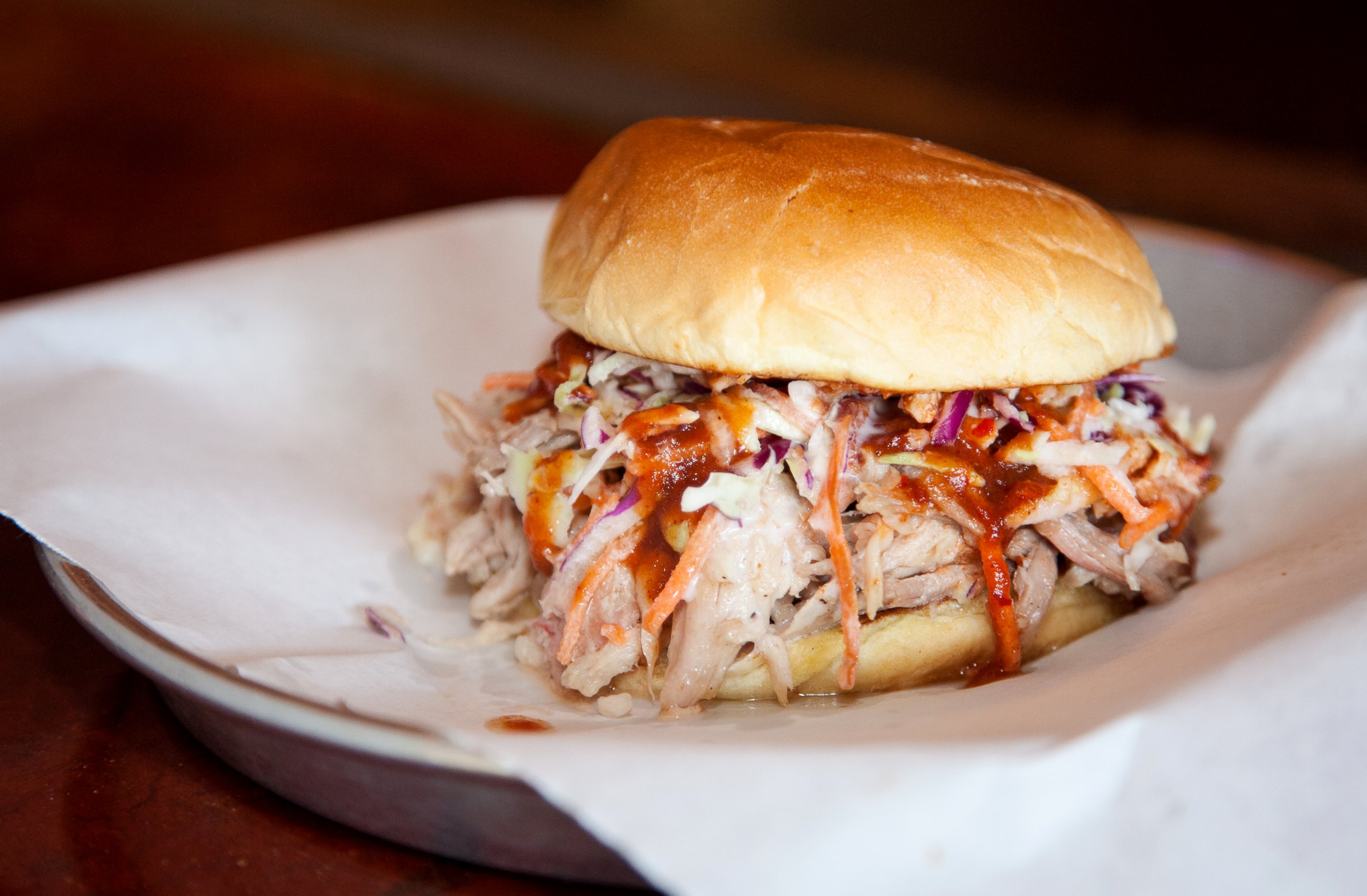 PHOTO: The barbecued pig is turned into a pulled pork sandwich with barbecue sauce and cole slaw on a roll.