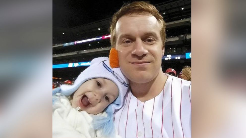 Brian Kucharik, 34, caught a foul ball during Thursday's Blue Jays versus Phillies game while holding his 4-year-old daughter Emily.