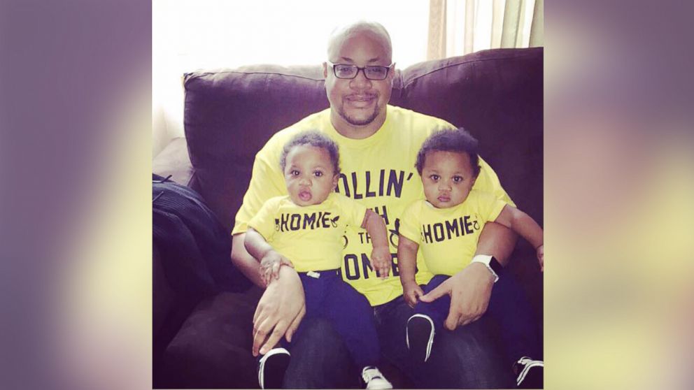 PHOTO: Kenny Moore, of Baltimore, Maryland, with his 12-month-old twins, Malcolm and Miles.