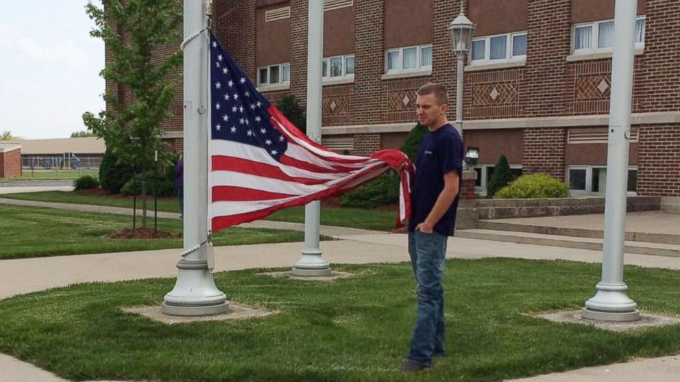 Cole Dotson stood outside his high school and held the American flag from touching the ground.