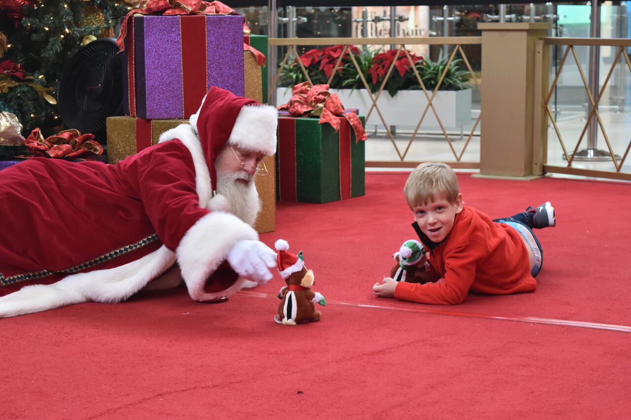 PHOTO: Brayden Deely, 6, took awhile to warm up to Santa so Santa got on the floor with him. 
