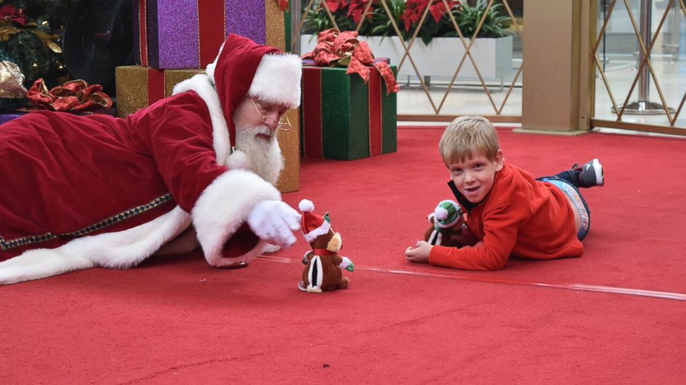 PHOTO: Brayden Deely, 6, took awhile to warm up to Santa so Santa got on the floor with him. 