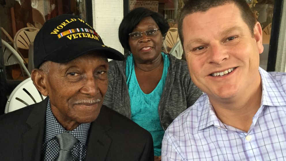 Johnnie Hodges Sr., 90, photographed with Greg Elwood last month on his front porch in Buffalo, New York after moving back into his home following eviction. 