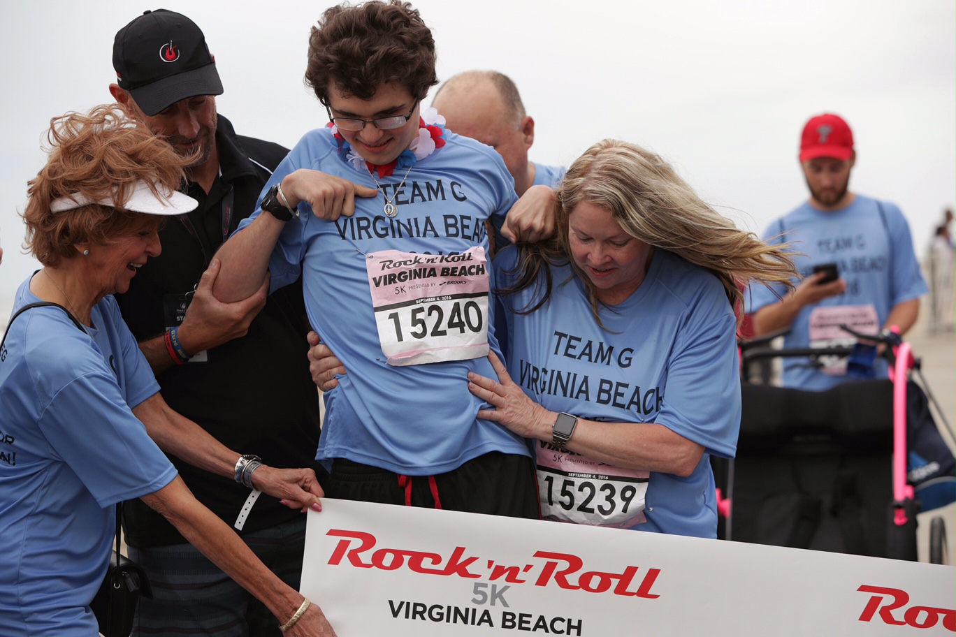 PHOTO: Greg Kenney Jr., who suffered a traumatic brain injury last year, walked across the finish line at the Rock 'n' Roll Half Marathon in Virginia Beach. 