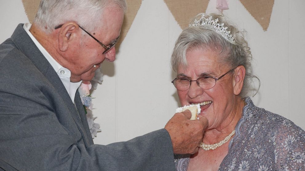 Johnny and Marcella Vick share a slice of cake at their wedding ceremony, which happened 63 years after they originally met and lost touch.
