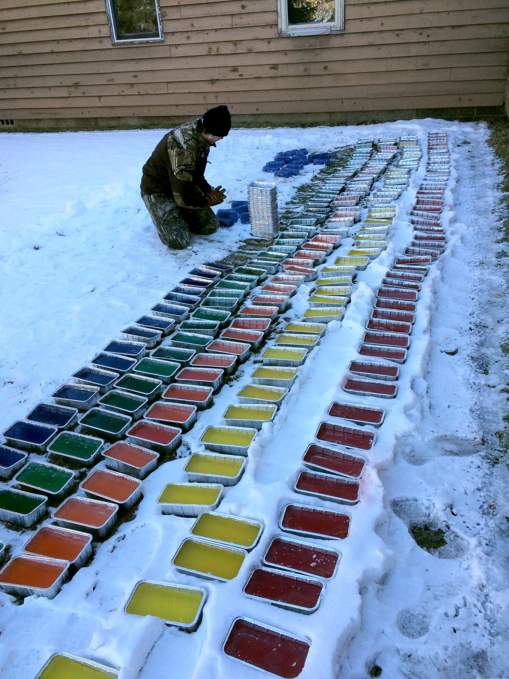 PHOTO: Mitch Fritz pops frozen water "building blocks" out of bread tins. Fritz used 500 blocks to build an igloo on the St. John's University campus in Collegeville, Minn.