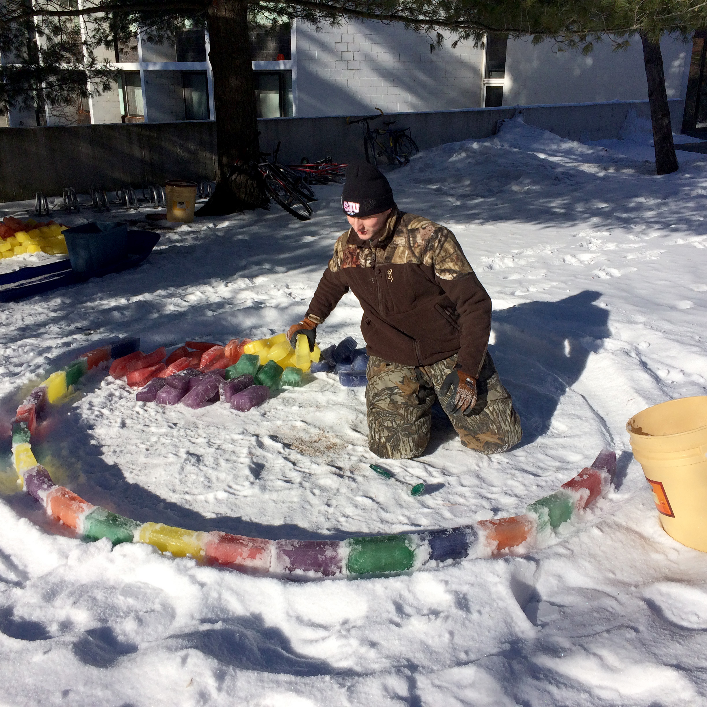 PHOTO: Mitch Fritz constructs an igloo on the St. John's University Campus in Collegeville, Minn. The freshman hockey player froze water and food coloring in bread tins to make the blocks.