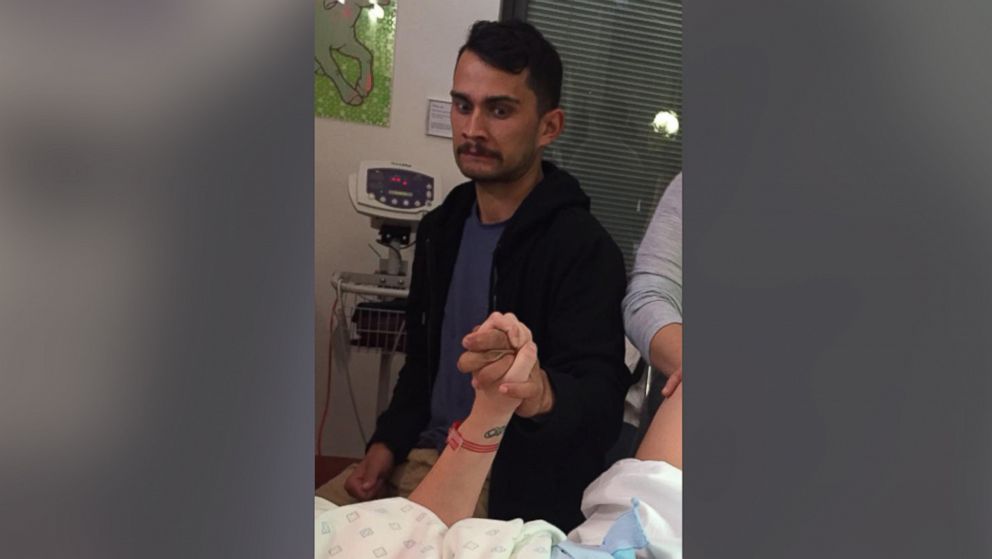 This photo of Jive Ria holding his partner's hand during childbirth has gone viral on Facebook.