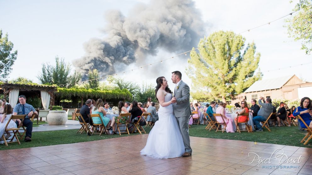 PHOTO: J.T. and Carly Morrissey scored memorable wedding photos thanks to a nearby fire Saturday, April 23 in Gilbert, Ariz.