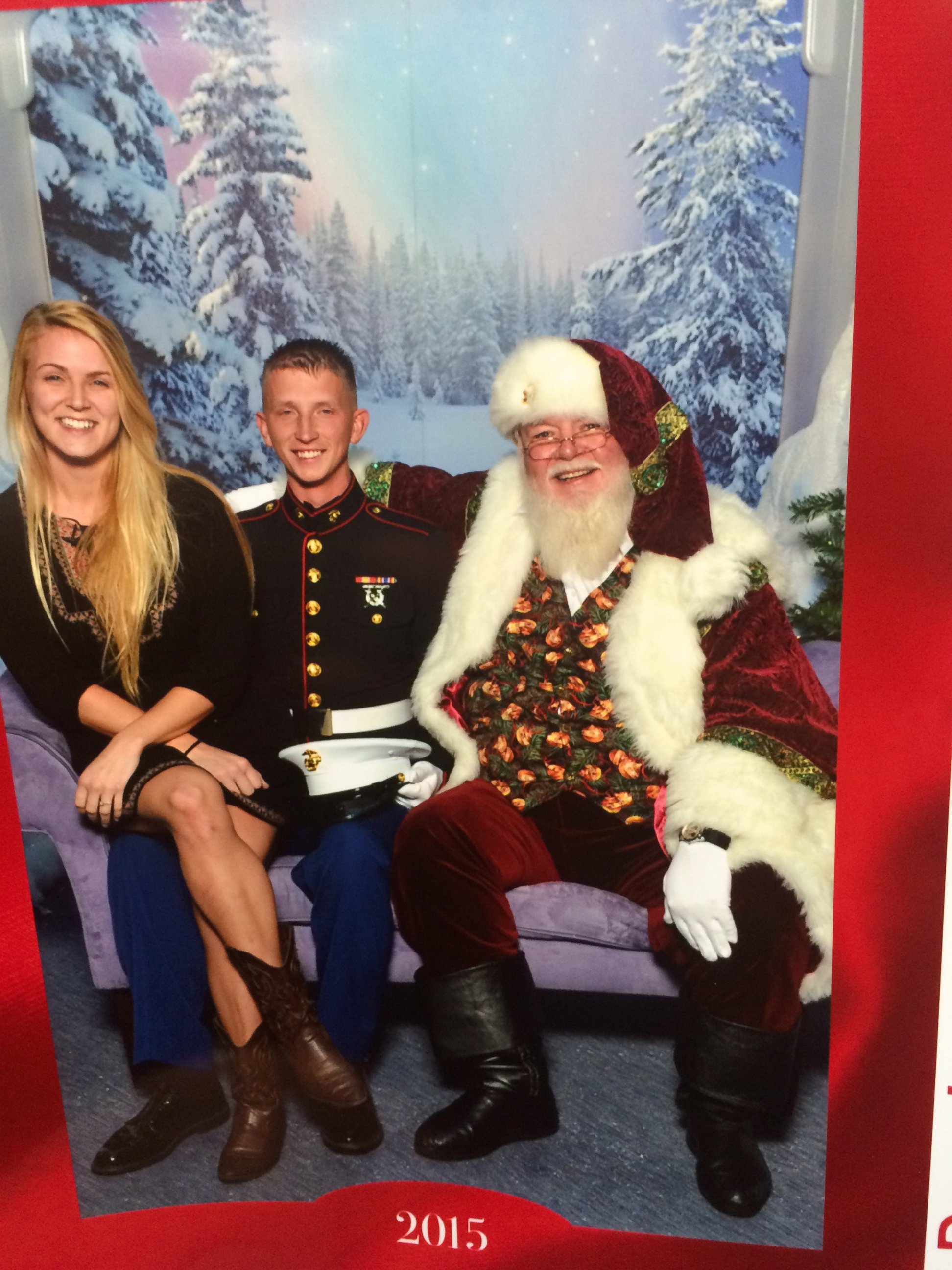 PHOTO: Marine Lance Corporal Peter Allen surprised his wife, Kellie Allen, with his early return for Christmas by sneaking behind her in a photo with a mall Santa in Wellington, Fla., Dec. 23, 2015. 