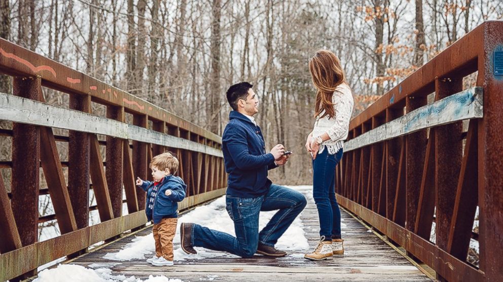 Adam Blum gets down on one knee to propose. 