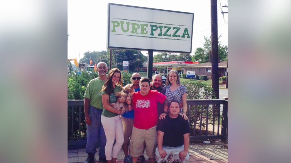 Pure Pizza Owner Juli Ghazi and her employees smile in front of the Charlotte, North Carolina store.