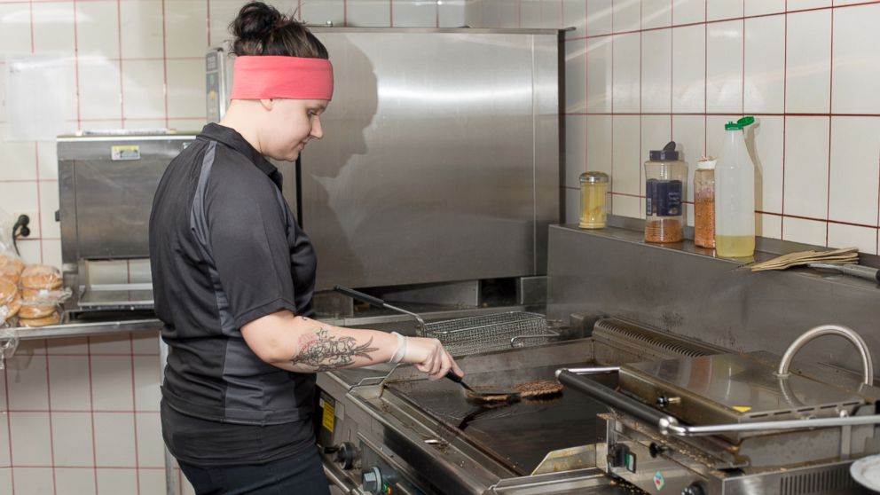 PHOTO: A kitchen worker at the cafe that claims it built the world's tallest burger.
