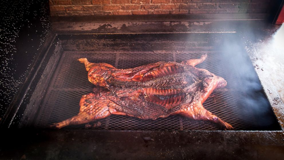 Barbecuing a whole hog takes constant supervision over 20-plus hours.