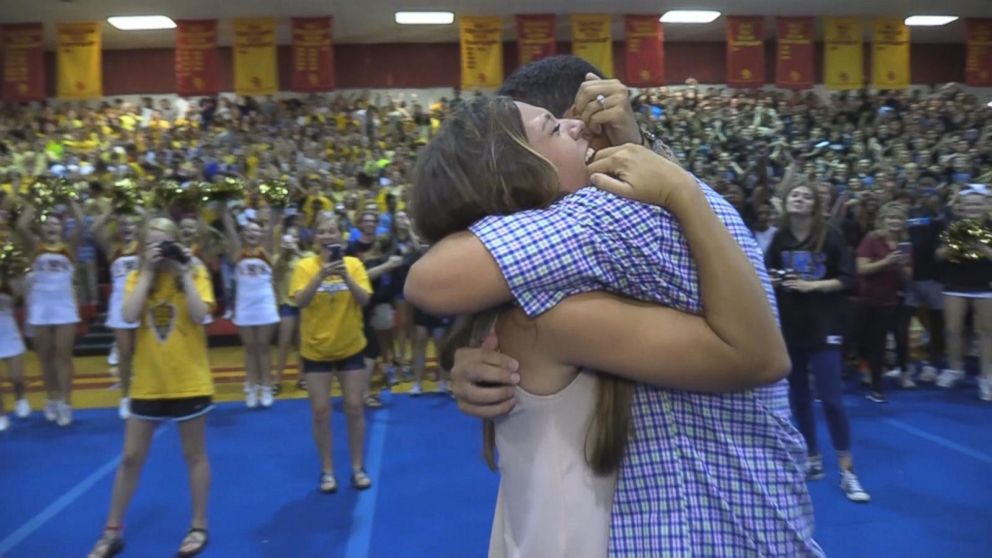 Robbie Galvin, 30, invited his girlfriend, Sydney Wright, 26, to the pep rally where he sang "I Want It That Way" by The Backstreet Boys before switching gears and performing "Marry You" by Bruno Mars.