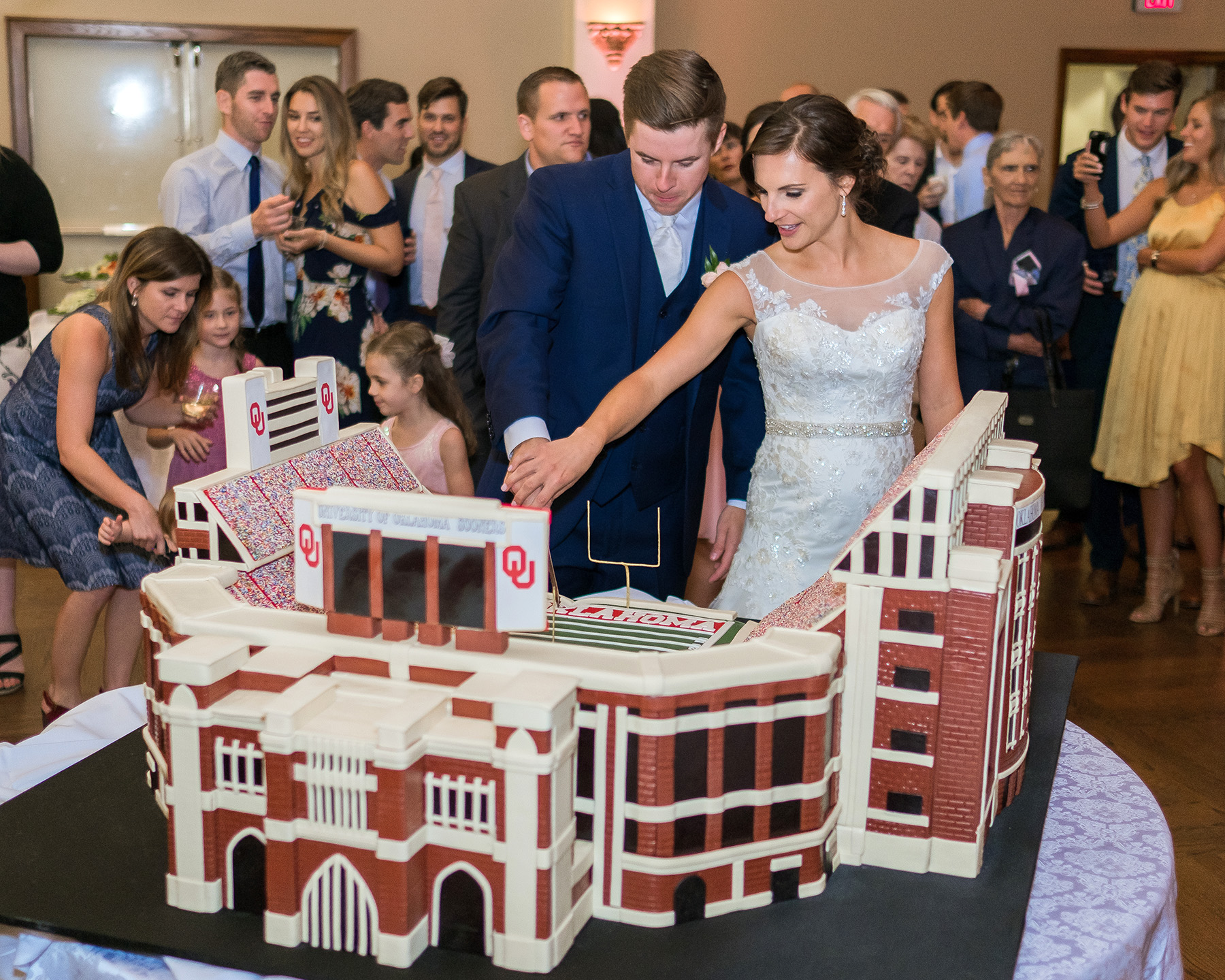 PHOTO: Bride Caddie Protor and groom Samuel Cox cut the cake on their wedding day. 