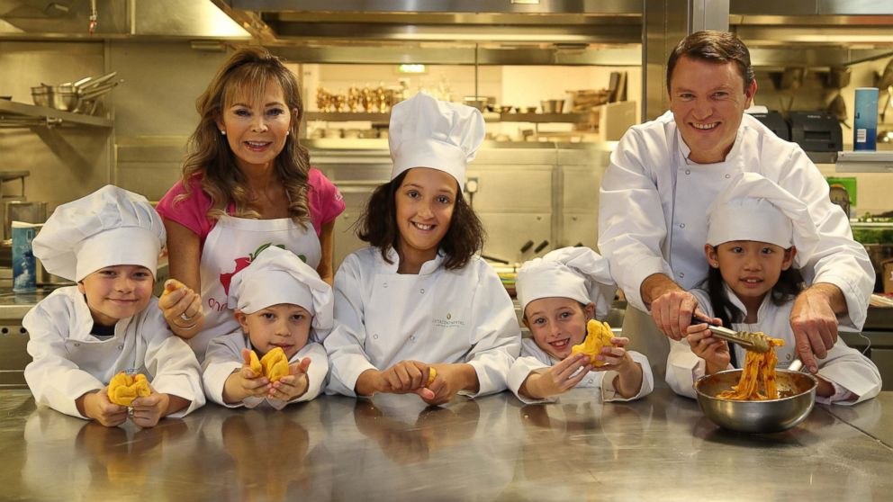 From left, children'?s food expert Annabel Karmel MBE and chef Theo Randall work with children on the new InterContinental Hotels and Resorts' children?'s menu.