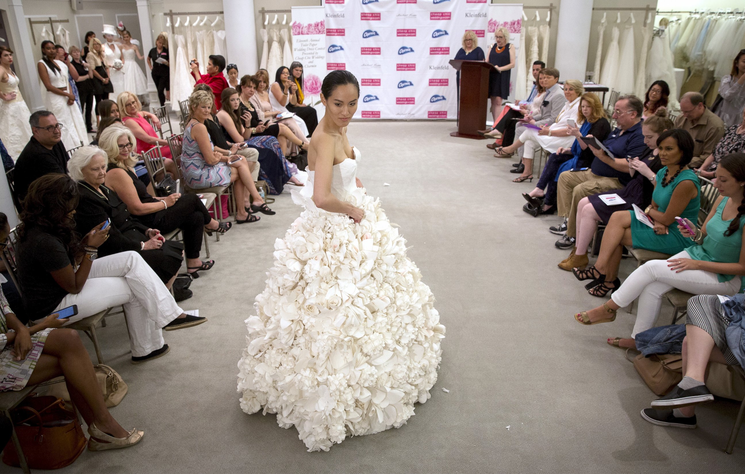 PHOTO: A model walks the runway wearing 'Garden Party' a design by Carol Touchstone during the 11th annual toilet paper wedding dress contest at Kleinfled's Bridal Boutique in New York, June 17, 2015. 