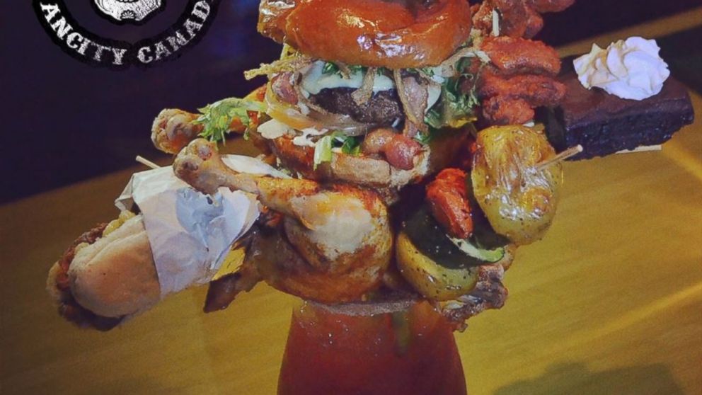 The Checkmate Caesar, available at Score on Davie in Vancouver, British Columbia, Canada, features chicken, a burger, hot dog, wings, vegetables and a brownie.