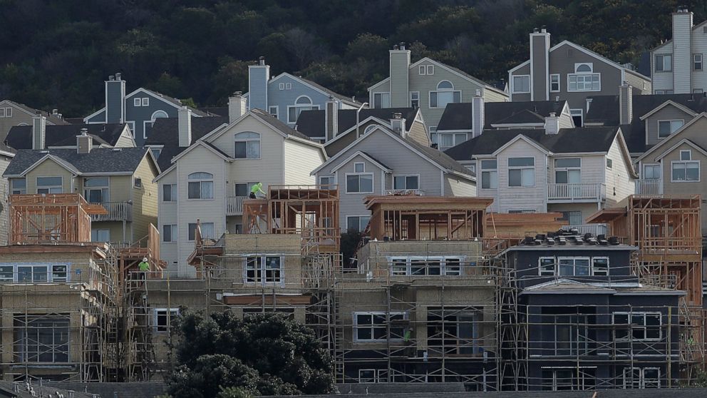 FILE - In this Feb. 20, 2020 file photo, a construction crew works on new homes in San Francisco. Your insurance policy is your safety net in case of a disaster, so you’ll want to ask a few important questions before forking over your premium. Learn 