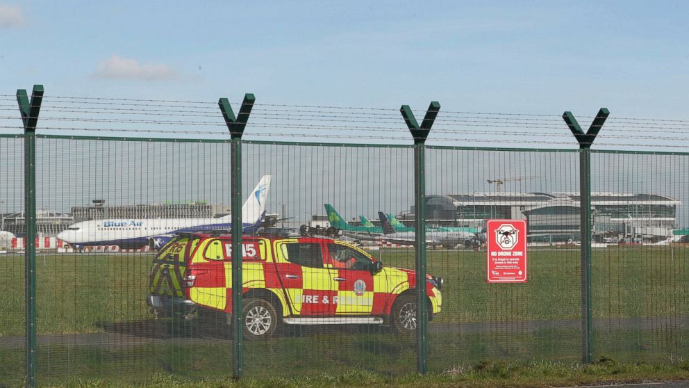 An emergency service vehicle by the perimeter fence after a confirmed drone sighting forced the temporary suspension of operations at Dublin Airport, Ireland, Thursday Feb. 21, 2019. Flights at Dublin Airport were grounded for a short time Thursday, 