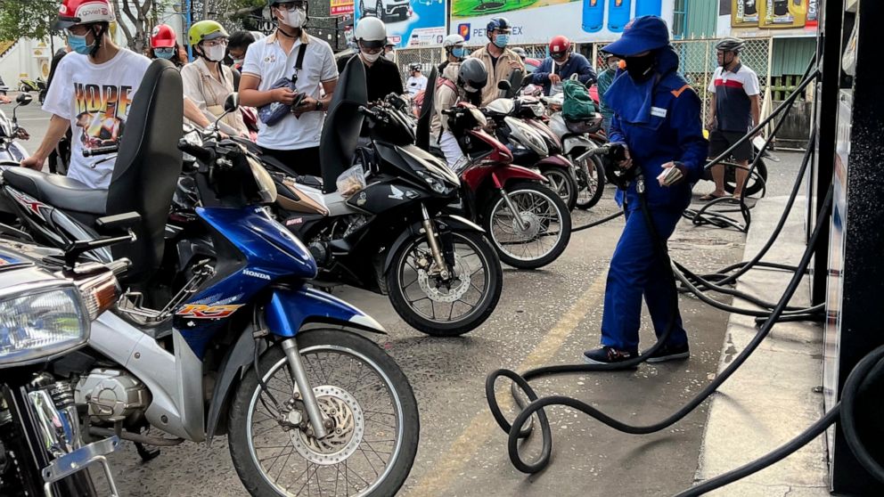 People wait for gas pump in Hanoi, Vietnam Sunday, June 19, 2022. Across the globe, drivers are rethinking their habits and personal finances amid skyrocketing prices for gasoline and diesel, fueled by Russia's war in Ukraine and the global rebound f