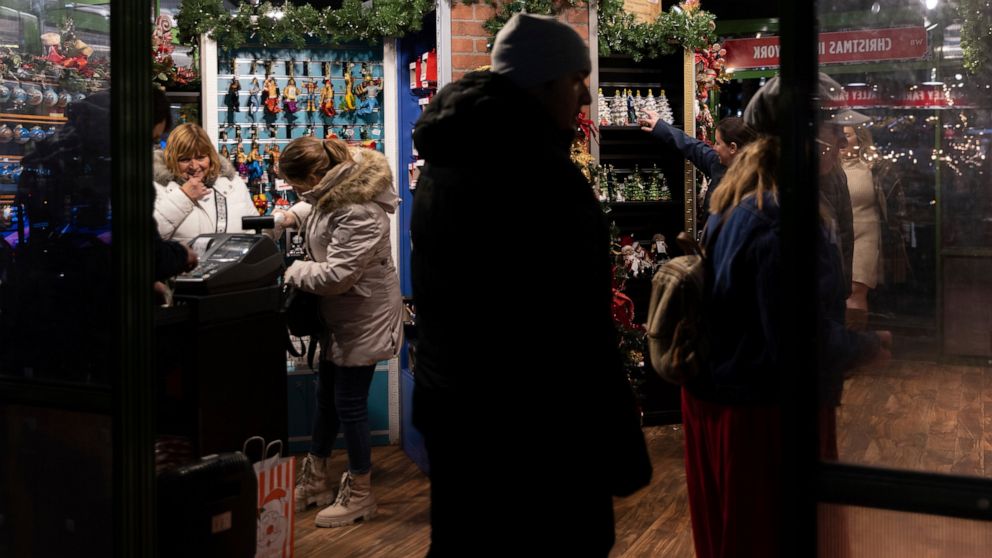 People shop for Christmas trinkets in Bryant Park's Winter Village, Tuesday, Nov. 15, 2022, in New York. After two years of pandemic holidays when people spent more dollars online, shoppers are back in force in stores and at holiday markets. Small bu