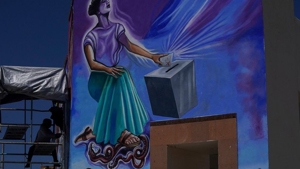 Mexican mural artist Yanet Calderon paints a mural in San Salvador, Mexico, Saturday, July 30, 2022. The mural in progress is on three walls of a municipal building in San Salvador, a small town of about 29,000 people north of Mexico City in Hidalgo 