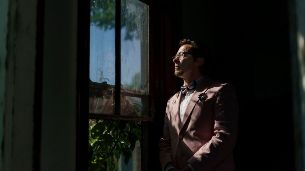 Scout, a transgender man who uses one name, stands in the entrance to his home in Providence, R.I., Wednesday, June 8, 2022. The 2020 census questionnaire drove Scout crazy. With no direct questions about sexual orientation and gender identity, it ma