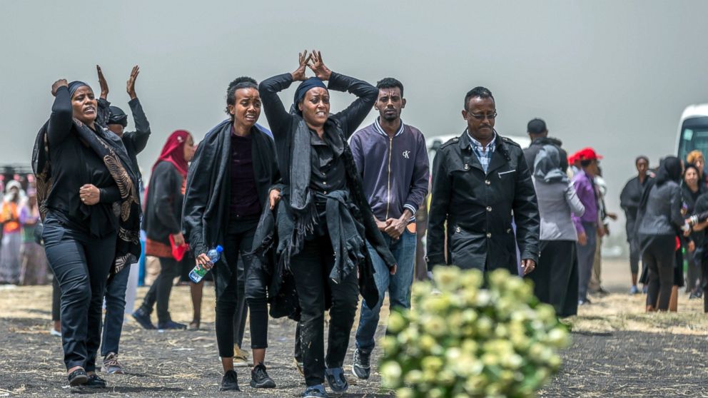 FILE - In this March 14, 2019 file photo, Ethiopian relatives of crash victims mourn at the scene where the Ethiopian Airlines Boeing 737 Max 8 crashed shortly after takeoff on Sunday killing all 157 on board, near Bishoftu, south-east of Addis Ababa