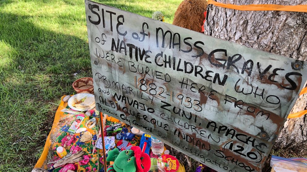 FILE - In this July 1, 2021, file photo, a makeshift memorial for the dozens of Indigenous children who died more than a century ago while attending a boarding school that was once located nearby is growing under a tree at a public park in Albuquerqu