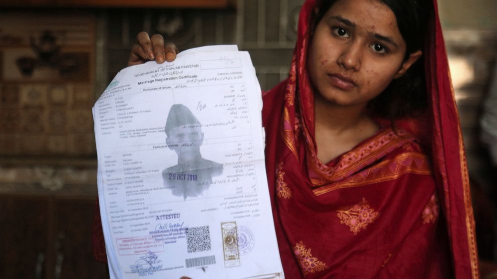 In this April 14, 2019 photo, Mahek Liaqat, who married a Chinese national, shows her marriage certificate in Gujranwala, Pakistan. Poor Pakistani Christian girls are being lured into marriages with Chinese men, whom they are told are Christian and w