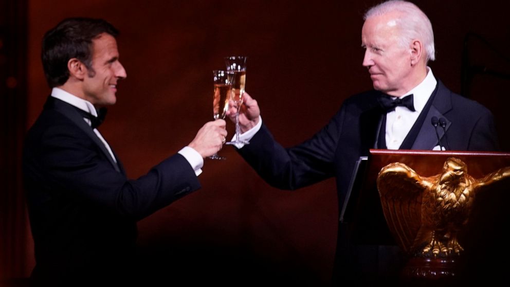 President Joe Biden and French President Emmanuel Macron toast during a State Dinner on the South Lawn of the White House in Washington, Thursday, Dec. 1, 2022. (AP Photo/Andrew Harnik)